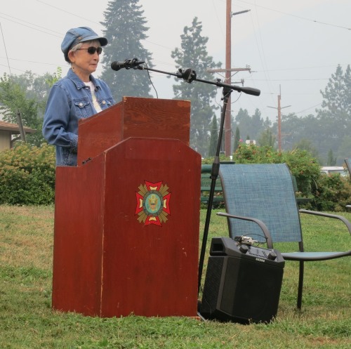 Hideko speaking while standing behind a podium
